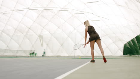 WIDE-SIDE-VIEW-Young-Caucasian-female-tennis-player-hitting-a-ball-during-game-or-practice.-100-FPS-slow-motion,-4K-UHD-RAW-graded-footage